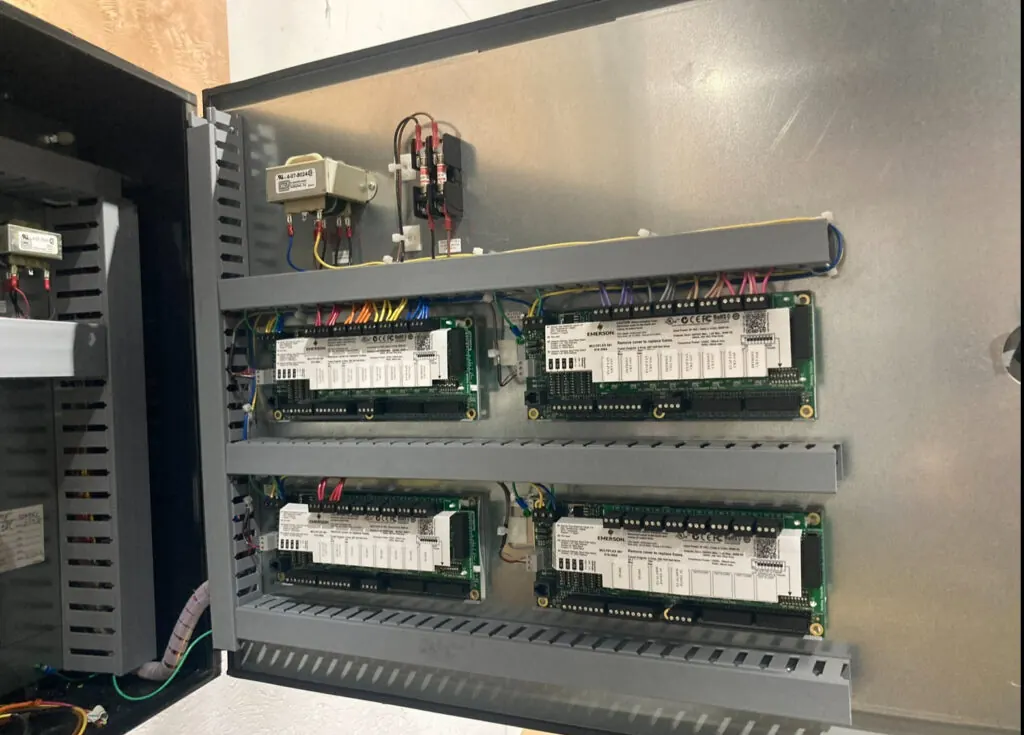 Refrigeration controller boards inside an open control cabinet